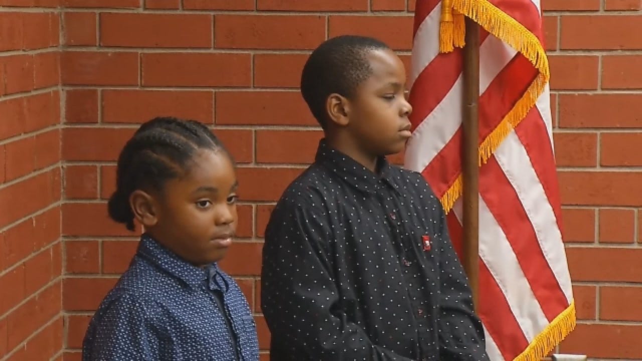 Boys Recite Pledge Of Allegiance Next To Flag Outside Fire Department
