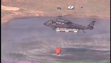 WEB EXTRA: National Guard Helicopter Dumping Water On Creek County Fire