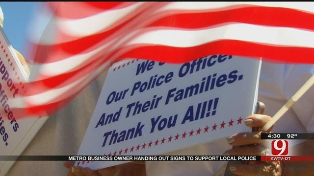 Metro Business Owner Handing Out Signs To Support Local Police