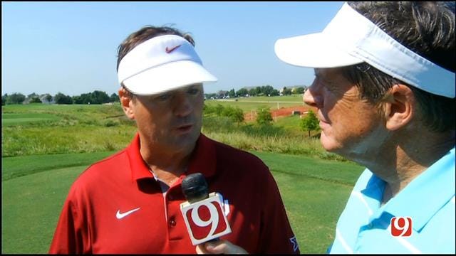 Bob Stoops Talks With Dean Blevins At the Sooner Golf Outing on Thursday