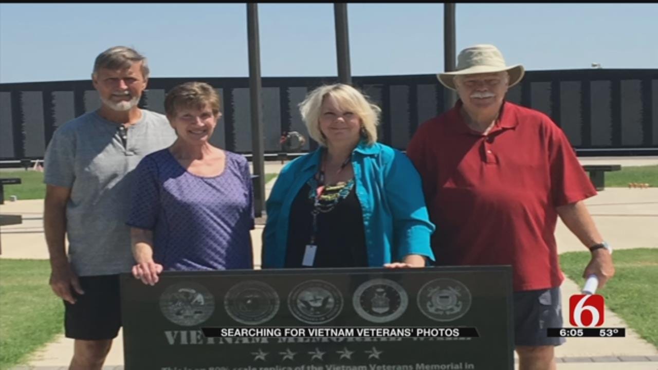 Man Searching For Pictures Of Oklahoma Veterans On Vietnam Memorial Wall