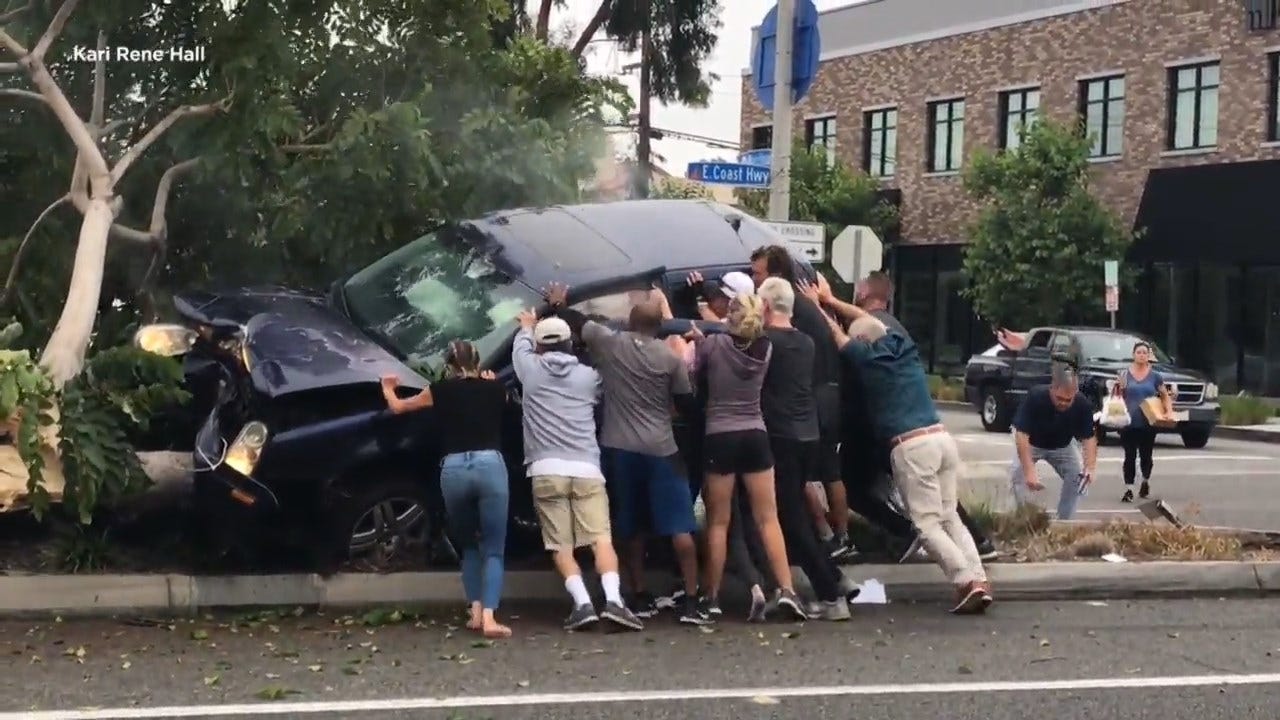 Dramatic Video Shows Group Of Strangers Save Passenger Trapped In Crashed SUV