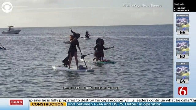 WATCH: Group of Witches, Warlocks Trade Brooms For Paddleboards