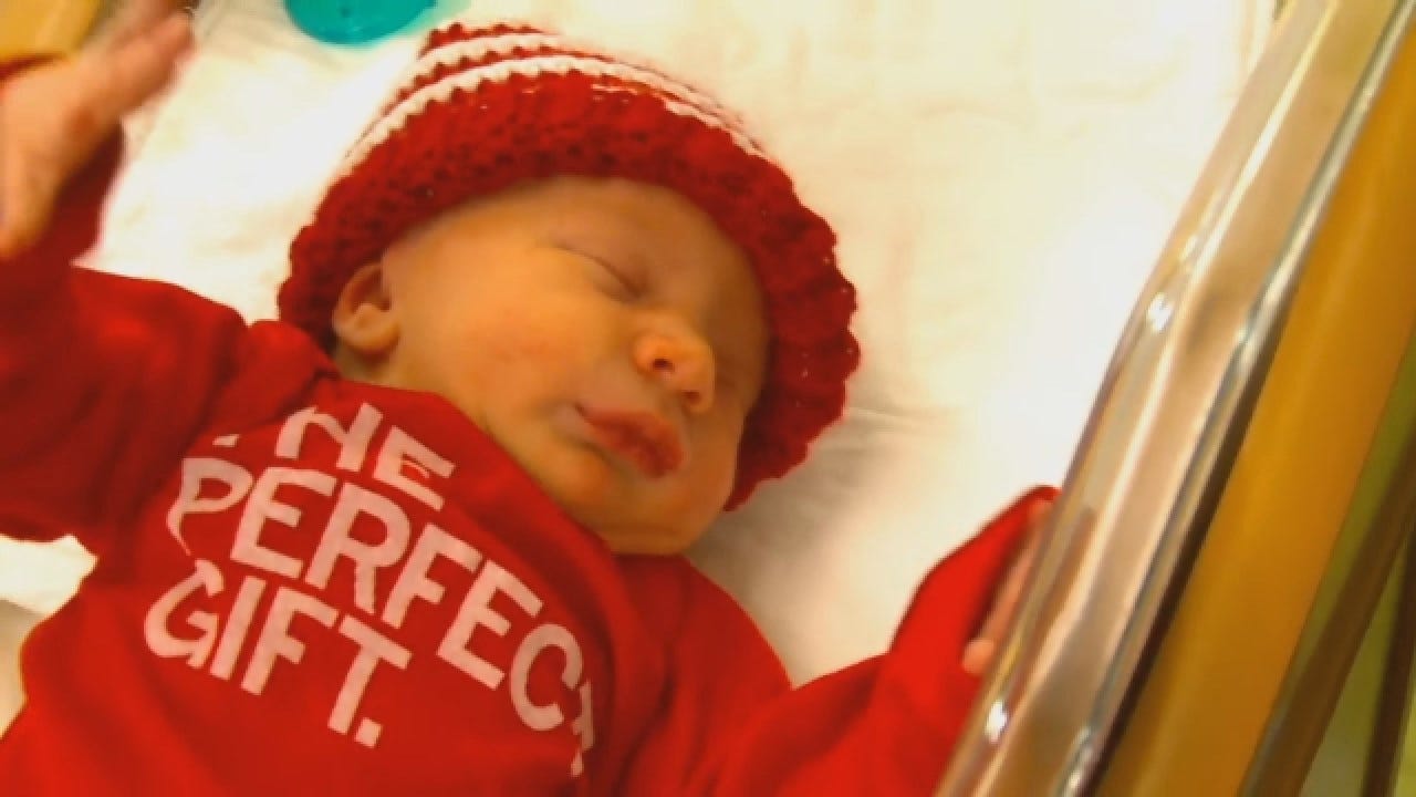 Newborns In Matching 'The Perfect Gift' Onesies
